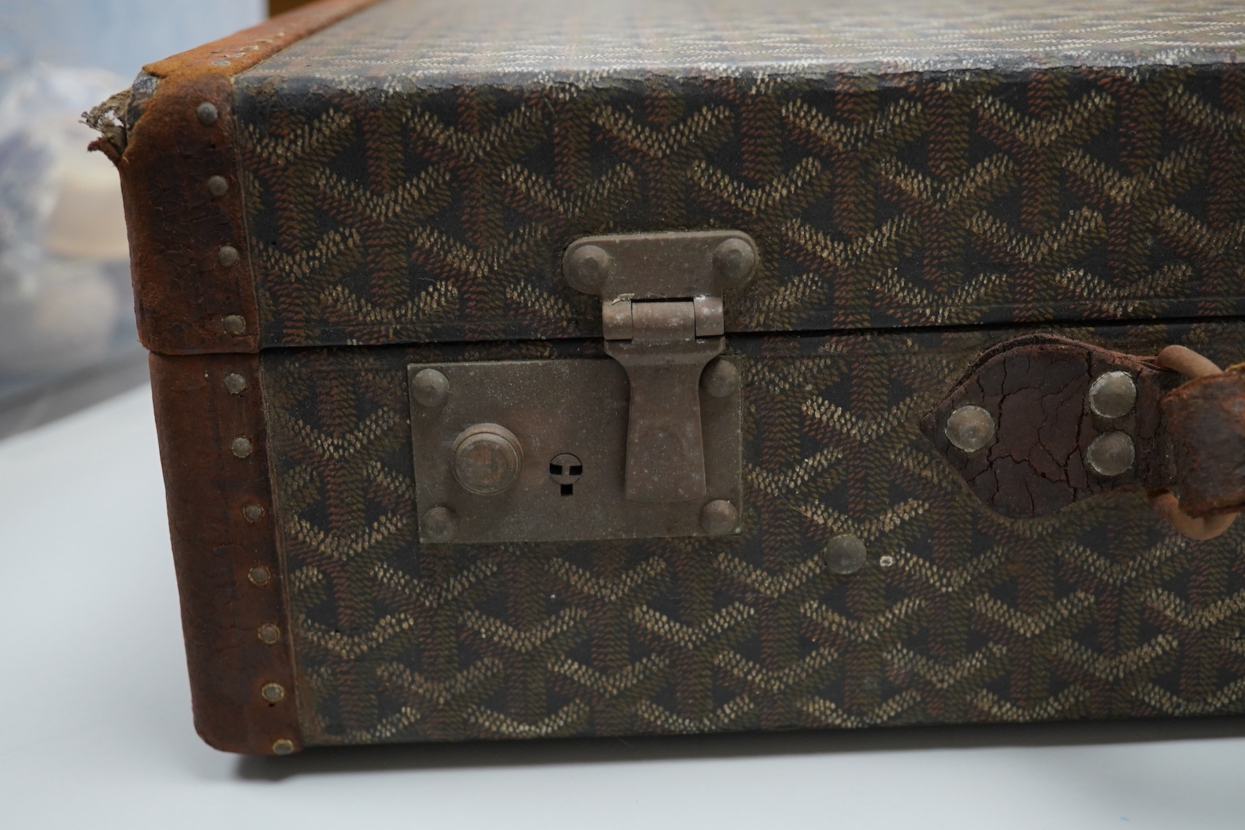 A vintage Malles Goyard suitcase with all over printed design, applied metal label to the exterior, height 13cm, width 49cm, depth 30cm